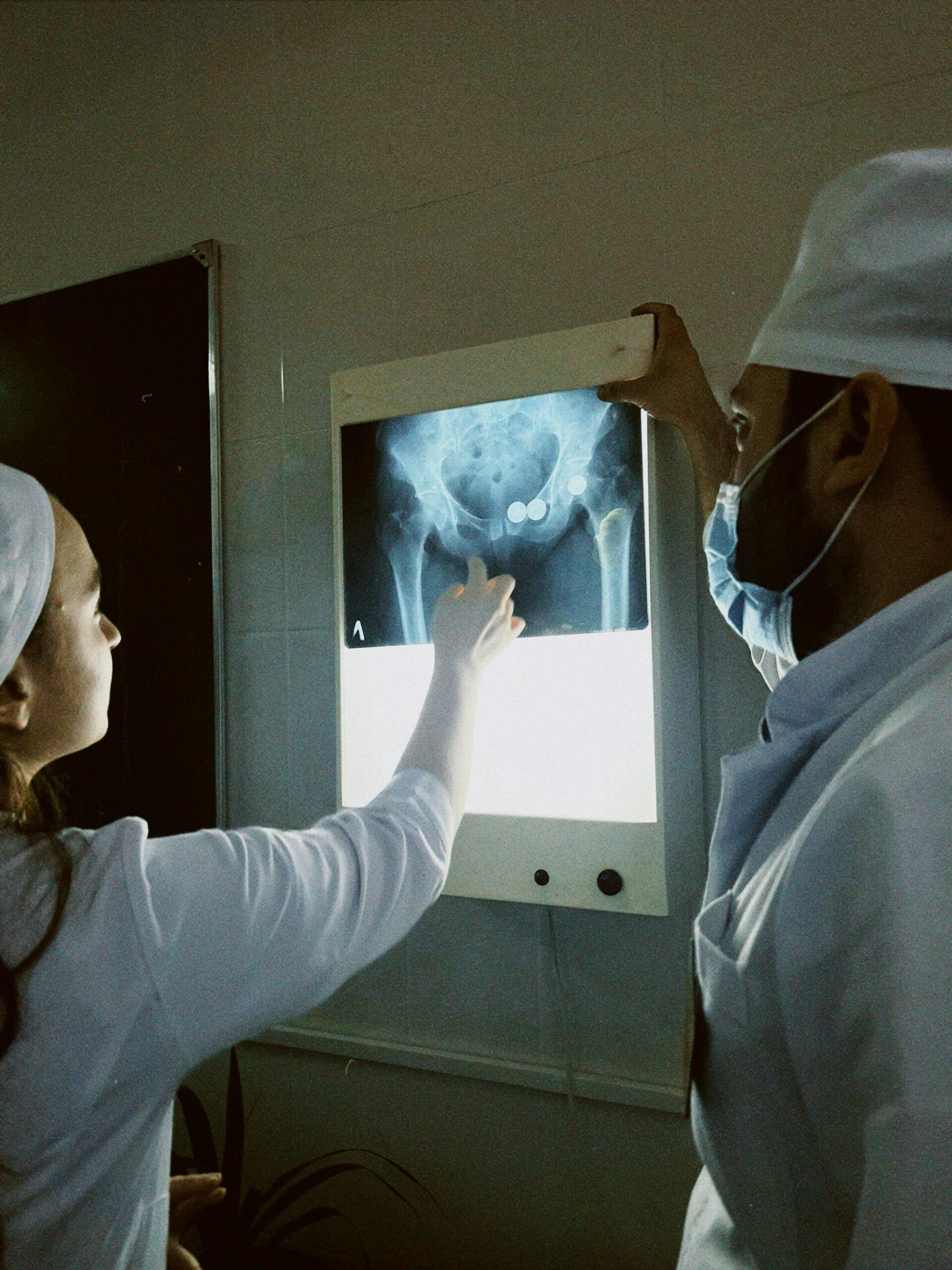 Medical professionals reviewing a hip x-ray, highlighting diagnosis and teamwork.
